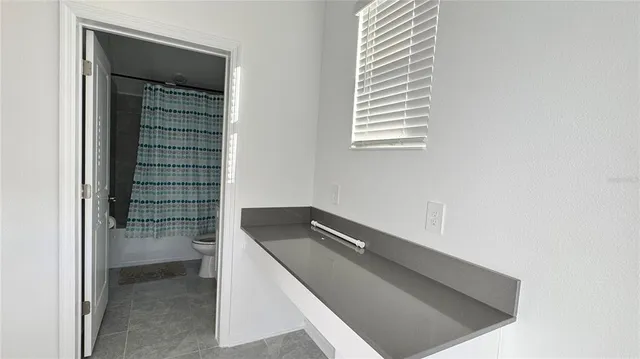 a view of room with window and hallway