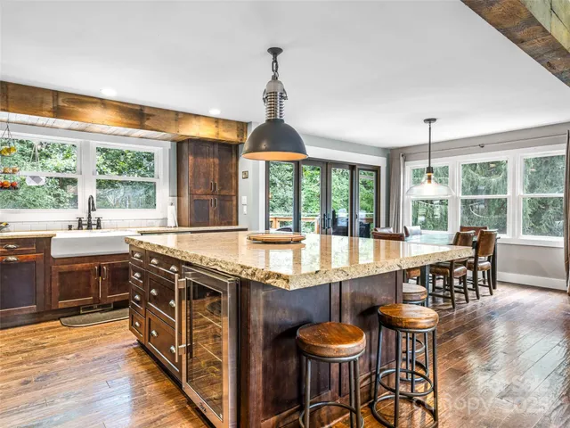 a large kitchen with a large window and dining table