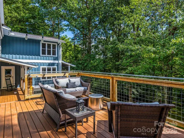 a balcony with wooden floor and furniture