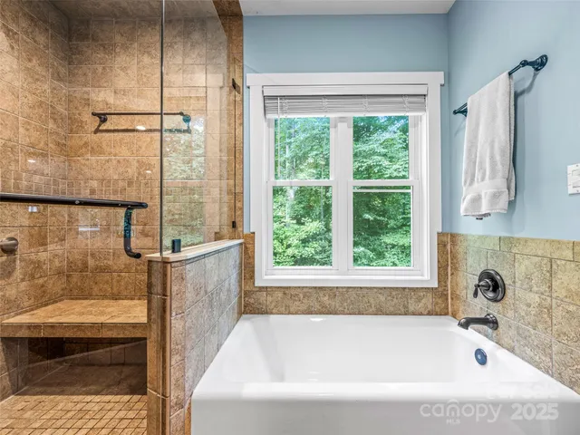 a bathroom with a bathtub and a shower