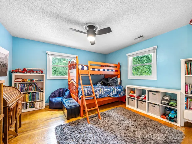 a bedroom with furniture and a flat screen tv