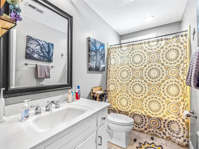 a bathroom with a sink toilet and a mirror