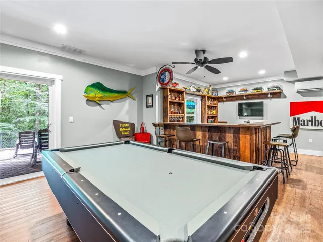 a room with stainless steel appliances kitchen island a table and chairs in it
