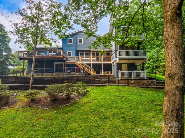 a view of a house with backyard porch and sitting area