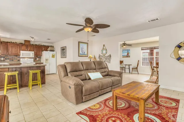 a living room with furniture and a kitchen view