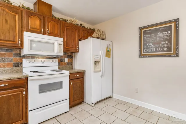 a kitchen with a stove cabinets and refrigerator