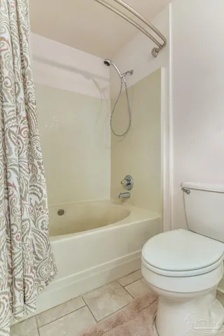 a bathroom with a toilet and a bath tub