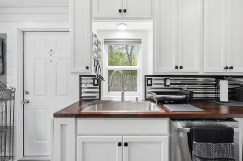 a kitchen with appliances a sink and cabinets