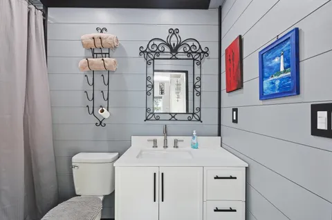 a bathroom with a sink vanity and a mirror