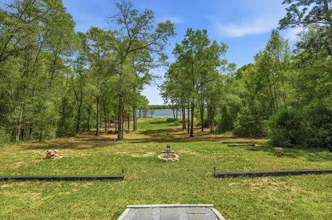 a view of a field with trees in the background