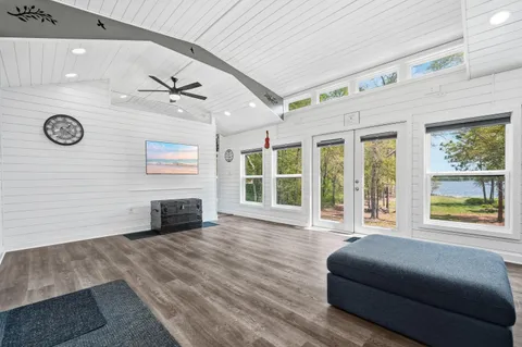 a living room with a bed furniture and a window