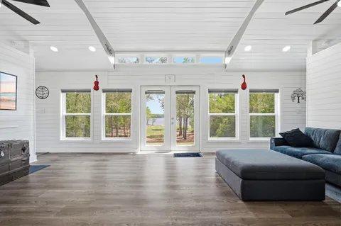 a living room with furniture and large windows