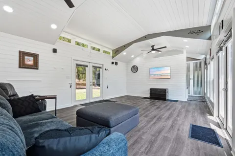 a living room with furniture and a wooden floor