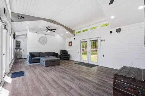 a living room with furniture and wooden floor