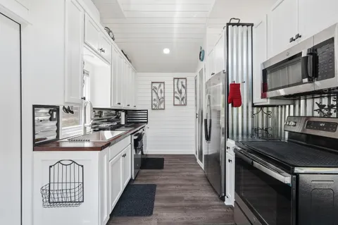 a kitchen with stainless steel appliances granite countertop a stove and a sink