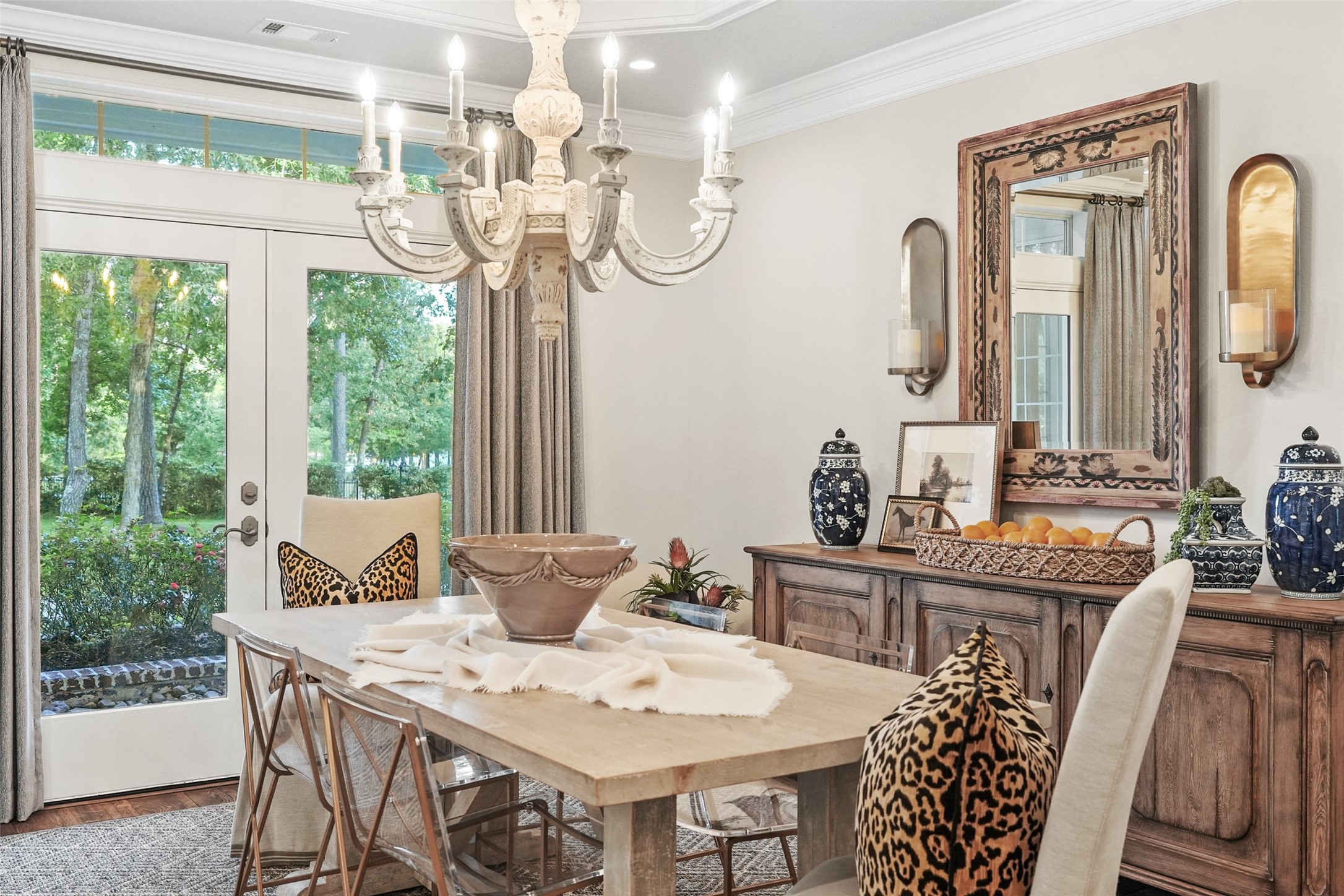 2207 Longmire Road Conroe, TX 77304 - Photo 12 of 46 a view of a dining room with furniture a chandelier and large windows