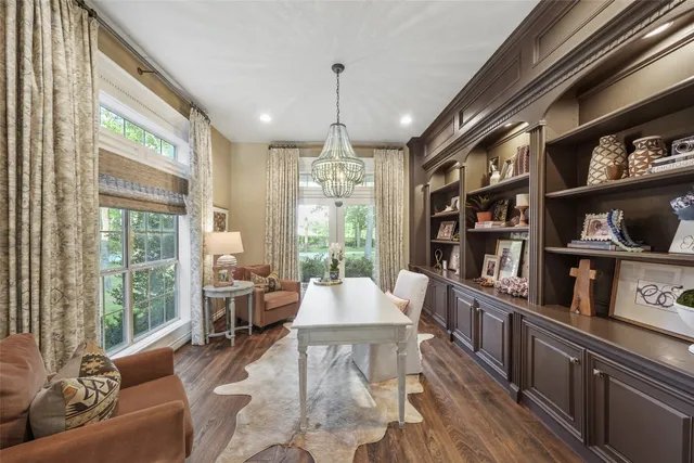 a living room with furniture and a book shelf