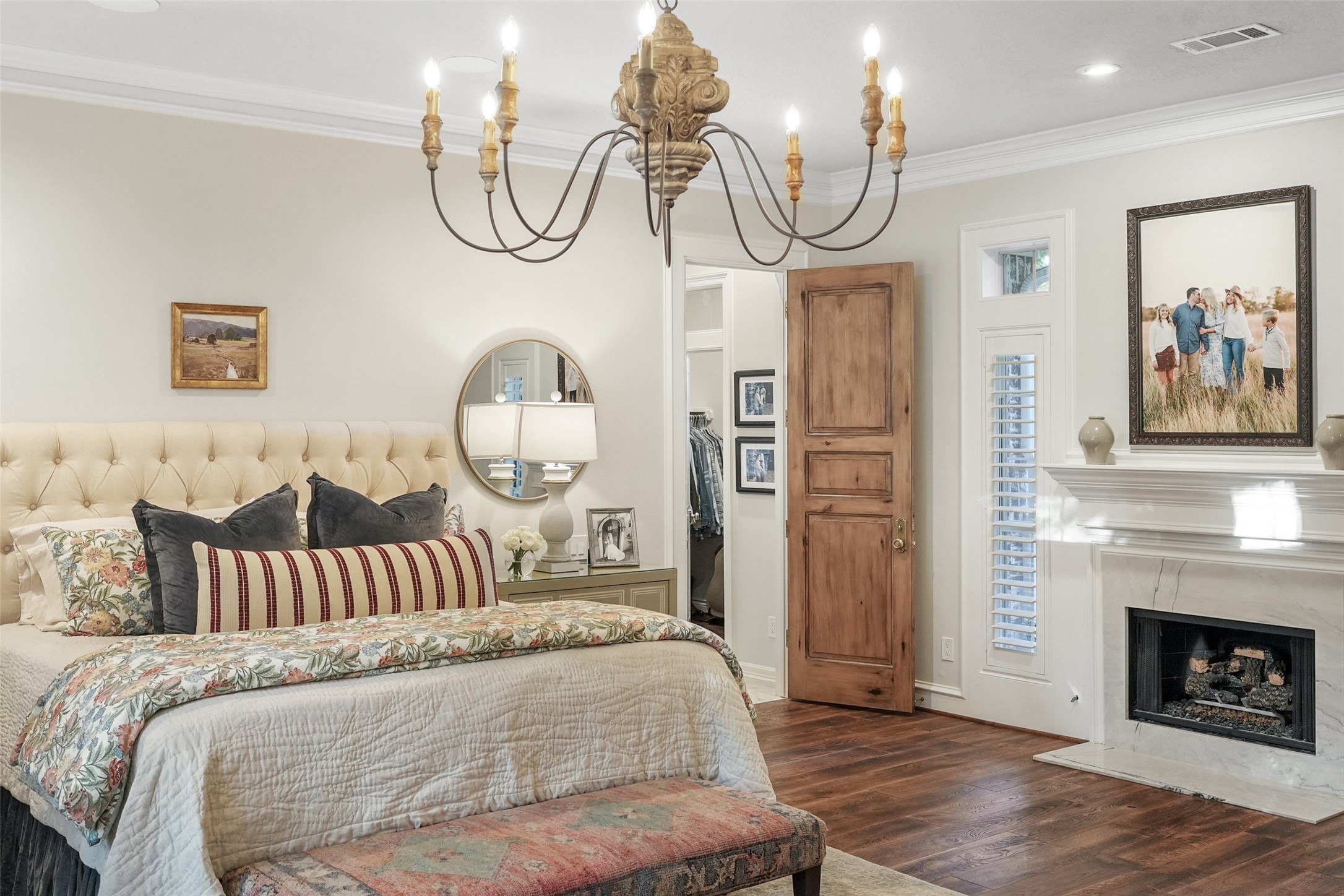 2207 Longmire Road Conroe, TX 77304 - Photo 20 of 46 a bedroom with bed and a chandelier