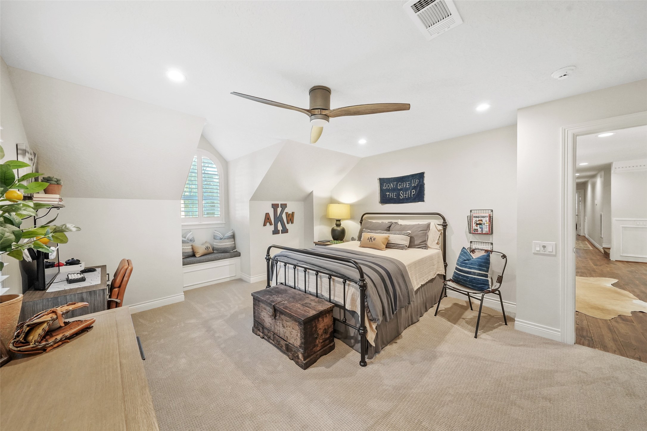 2207 Longmire Road Conroe, TX 77304 - Photo 28 of 46 a bedroom with a bed a chair and potted plant on the table