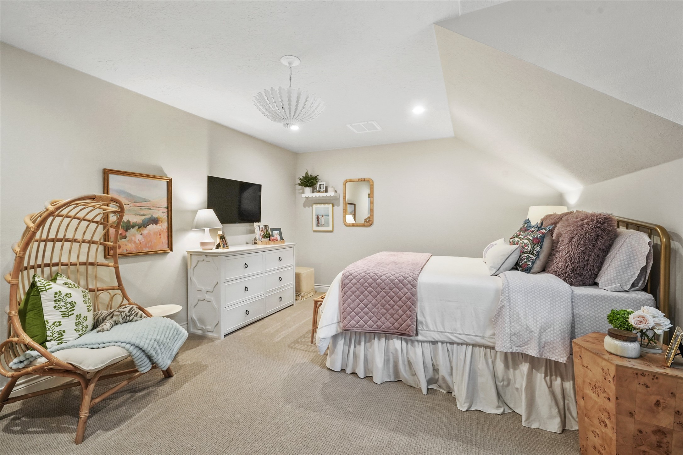 2207 Longmire Road Conroe, TX 77304 - Photo 29 of 46 a spacious bedroom with a bed and a chair