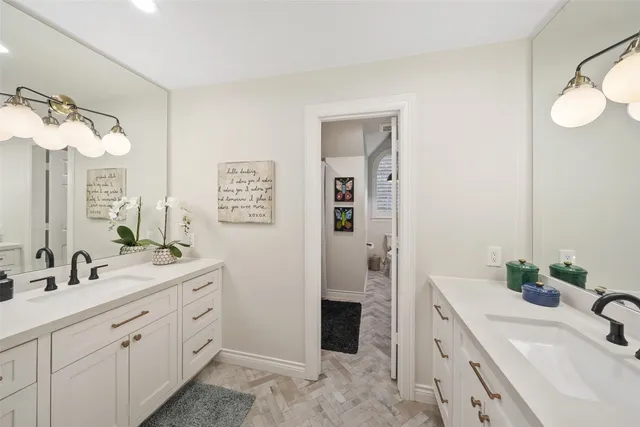a bathroom with a double vanity sink mirror and shower