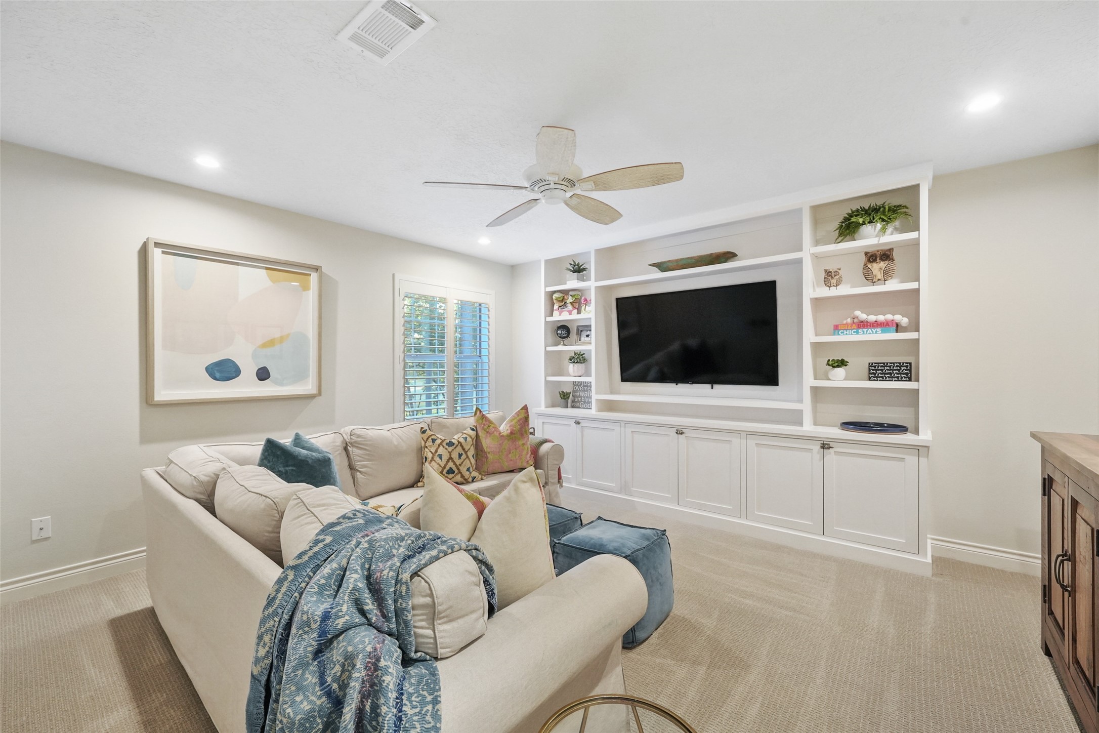 2207 Longmire Road Conroe, TX 77304 - Photo 31 of 46 a living room with furniture and a flat screen tv