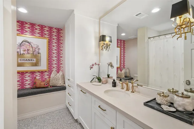 a bathroom with a sink mirror and vanity