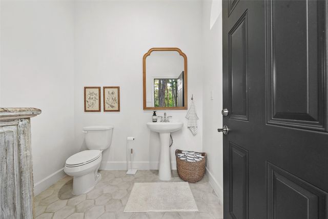 a bathroom with a toilet a sink and mirror