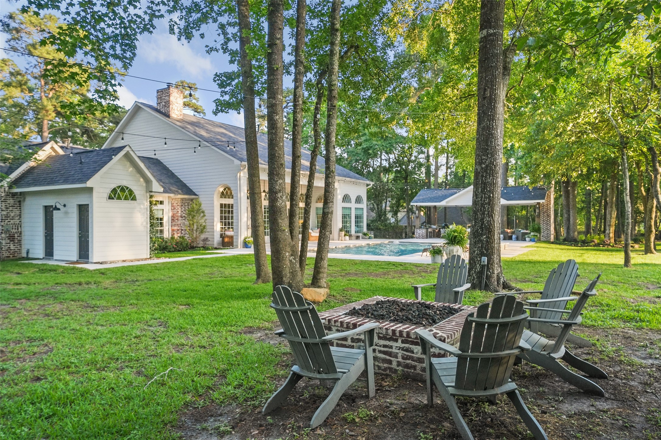 2207 Longmire Road Conroe, TX 77304 - Photo 41 of 46 a view of a house with a yard and patio