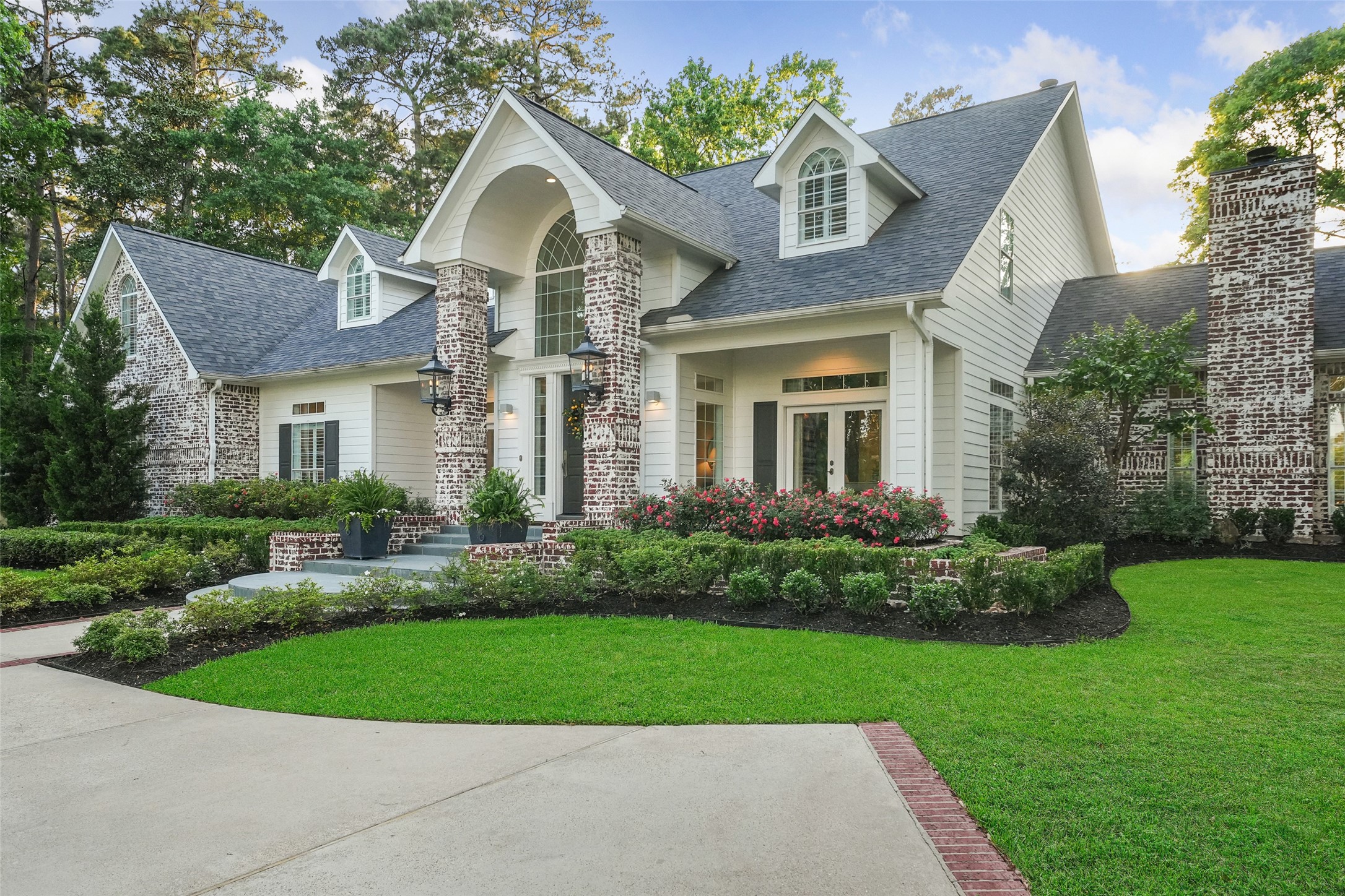 2207 Longmire Road Conroe, TX 77304 - Photo 9 of 46 a front view of a house with a yard and garage