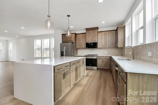 a open kitchen with stainless steel appliances granite countertop a sink stove and refrigerator