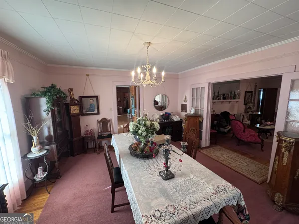 a dining room with furniture and a chandelier