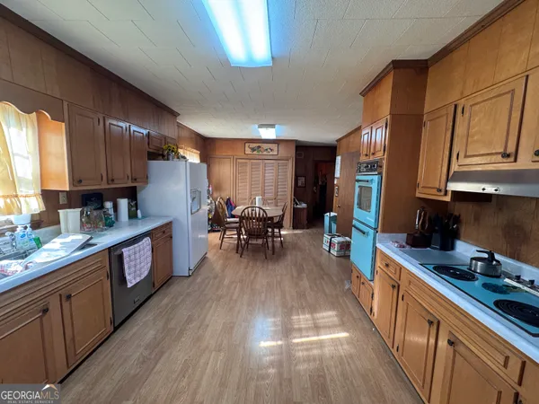 a kitchen with lots of counter top space and wooden floor