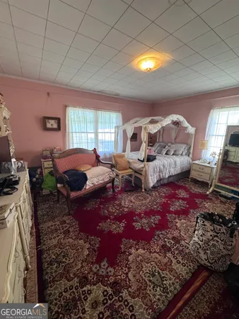 a living room with furniture hard wood floor and a rug