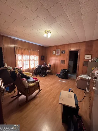 a living room with furniture gym equipment and a flat screen tv