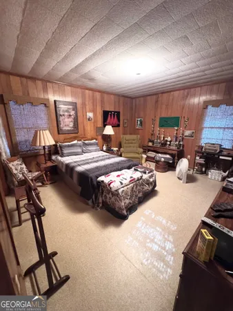 a bedroom with furniture a bed a window and mirror