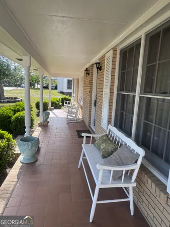 a view of a patio with table and chairs potted plants with wooden floor