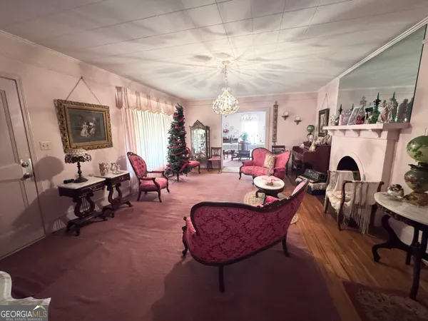 a living room with furniture fireplace and window