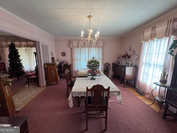 a view of a dining room with furniture and window