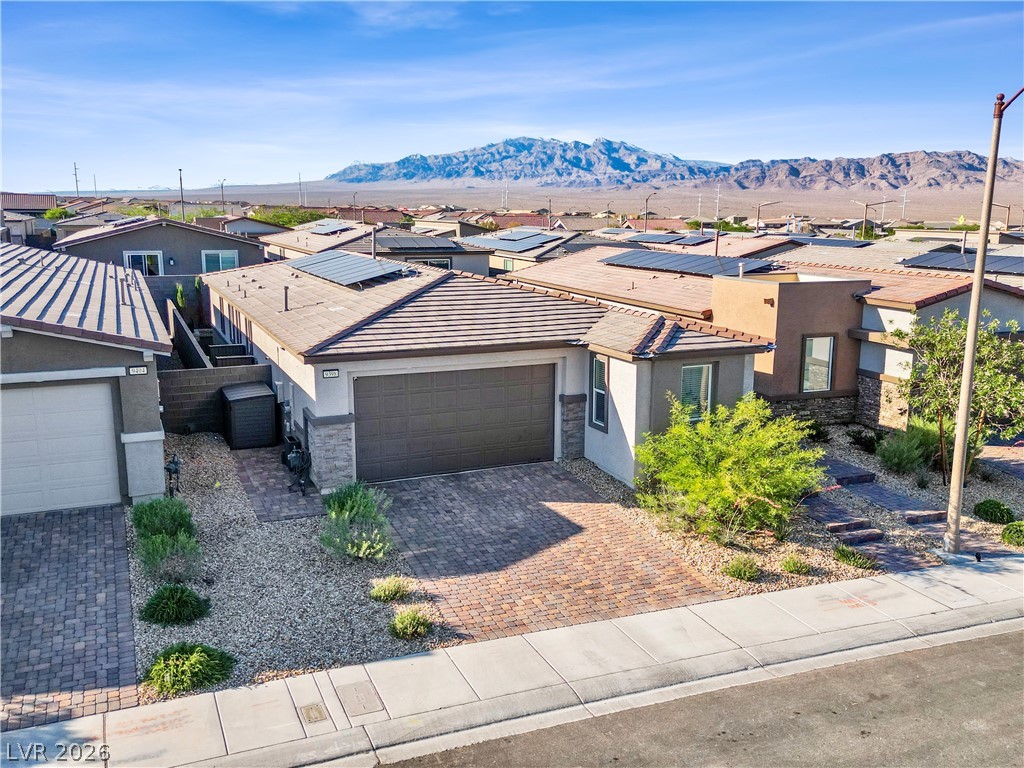 9398 Noble Fir Rdg Court Las Vegas, NV 89143 - Photo 1 of 36 A desert-friendly front yard and driveway with mountain views frame this charming residence.