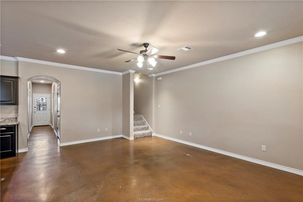 4295 Commando Trail College Station, TX 77845 - Photo 4 of 25 an empty room with wooden floor and a ceiling fan