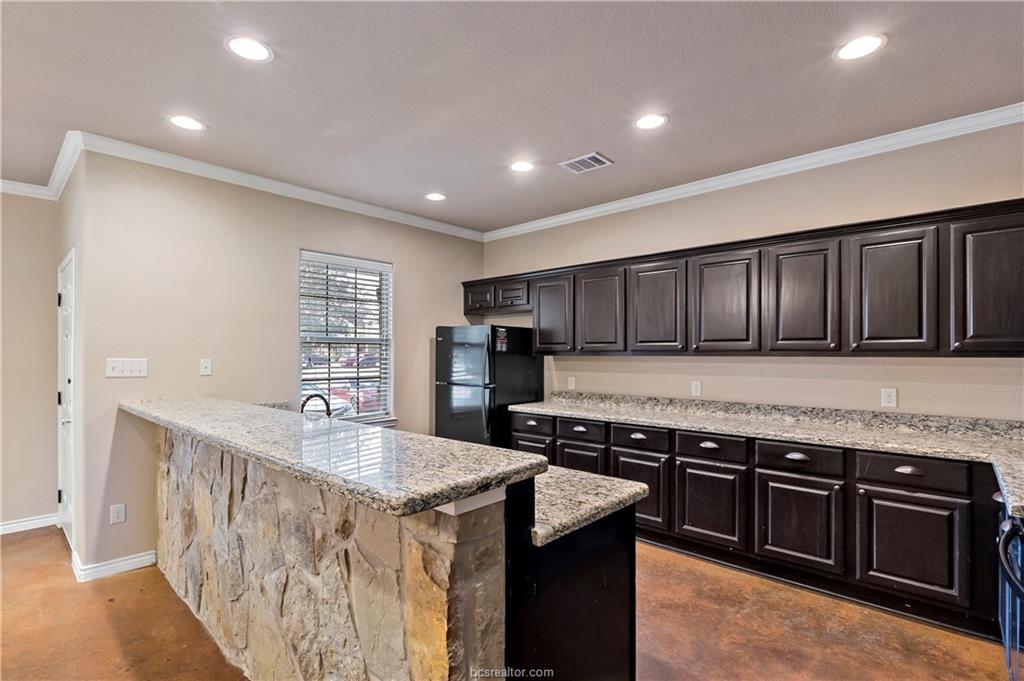4295 Commando Trail College Station, TX 77845 - Photo 8 of 25 a kitchen with stainless steel appliances granite countertop a stove a sink and a refrigerator