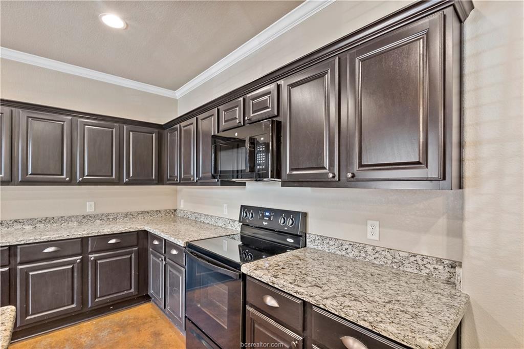 4295 Commando Trail College Station, TX 77845 - Photo 10 of 25 a kitchen with stainless steel appliances granite countertop a sink stove and microwave