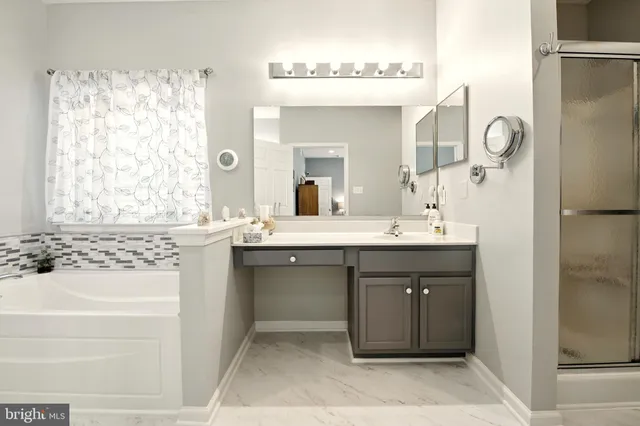 a bathroom with a double vanity sink mirror and shower