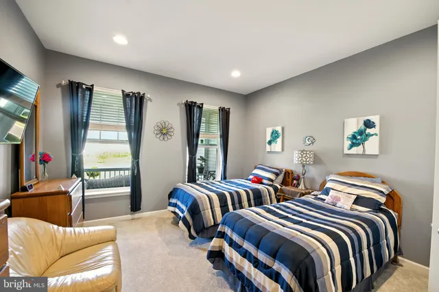 a bedroom with two beds and a couch