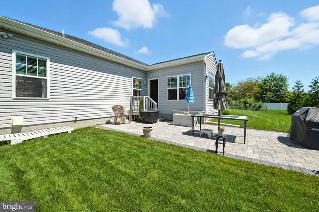a house view with a sitting space and garden