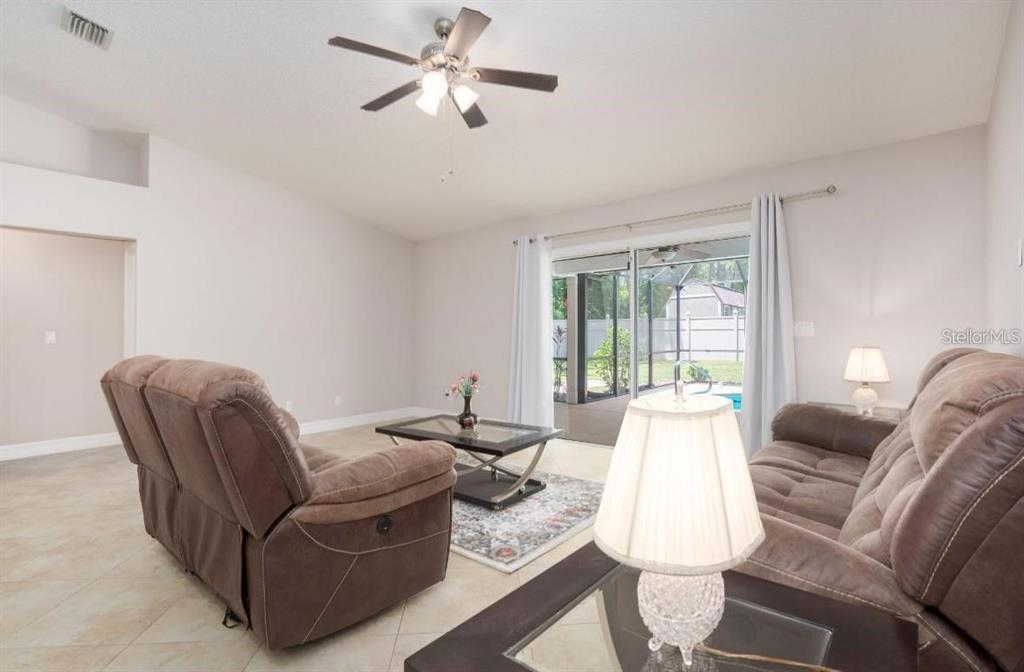 29 Rybark Lane Palm Coast, FL 32164 - Photo 13 of 41 a living room with furniture and a large window