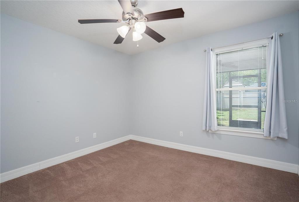 29 Rybark Lane Palm Coast, FL 32164 - Photo 25 of 41 an empty room with a window and a fan