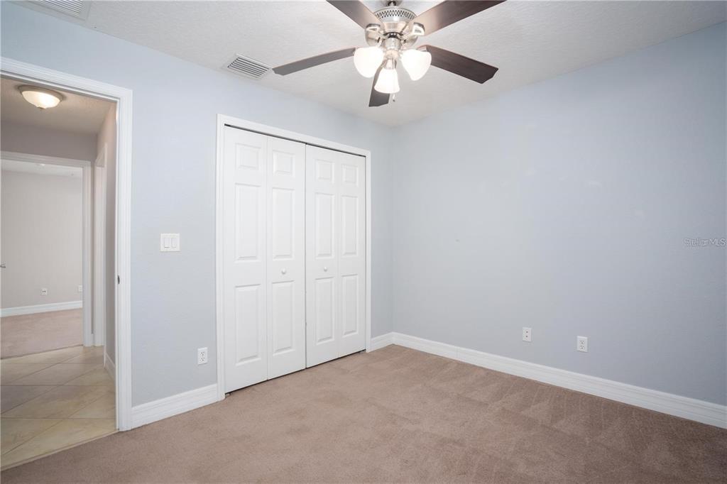 29 Rybark Lane Palm Coast, FL 32164 - Photo 26 of 41 an empty room with a chandelier fan and closet area