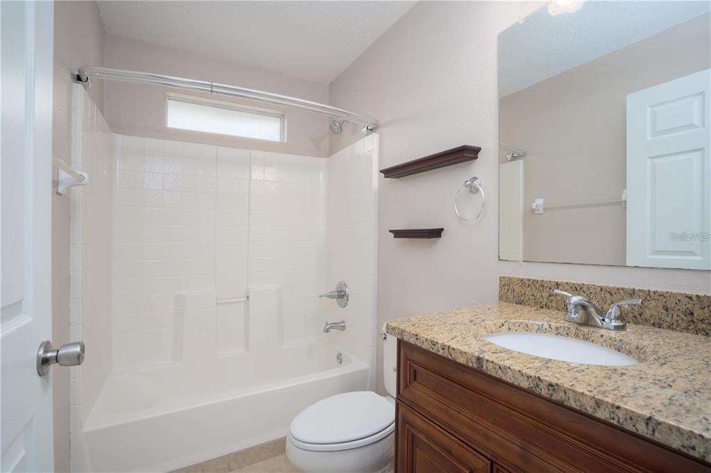 29 Rybark Lane Palm Coast, FL 32164 - Photo 27 of 41 a bathroom with a granite countertop sink toilet and shower